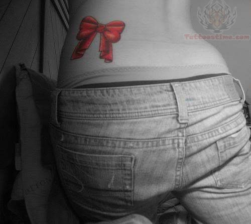 Color Ink Bow Tattoo On Lowerback